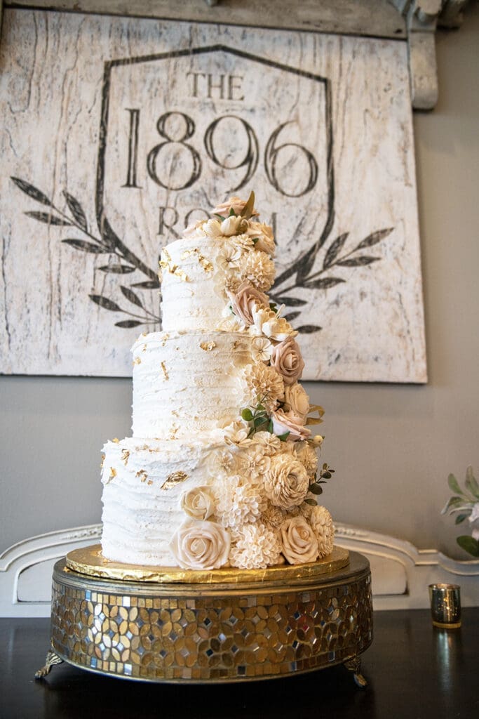 The 1896 room at the Carriage House in Ocononowoc, WI for weddings. The photo is of an elegant wedding cake. Unscripted Wedding Co is the photographer and videographer.