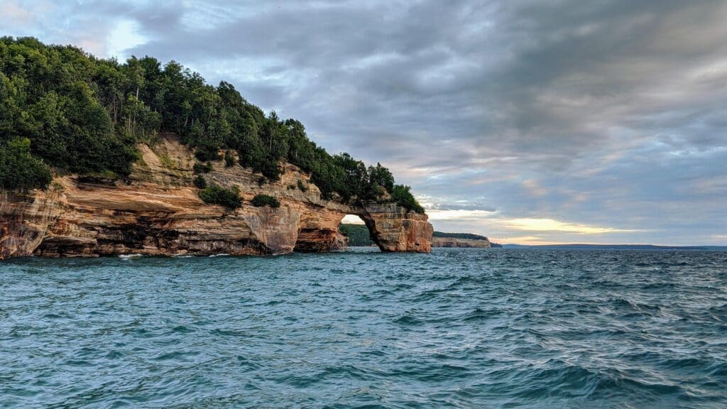 Pictured Rocks National Lakeshore in Michigan showcases dramatic sandstone cliffs, crystal-clear waters, and pristine beaches, making it a breathtaking destination for an elopement. Couples can say their vows surrounded by the natural beauty of the lake and colorful rock formations.